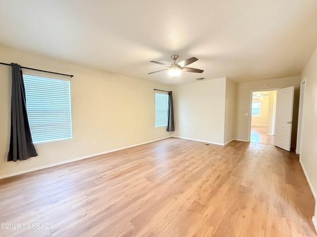 spare room featuring light hardwood / wood-style flooring and ceiling fan