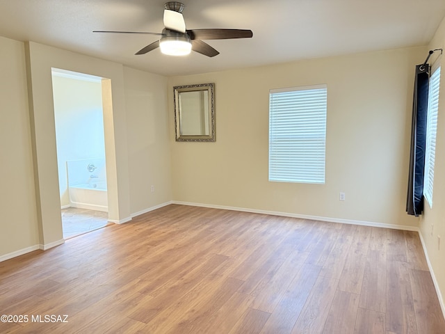 empty room with ceiling fan and light wood-type flooring