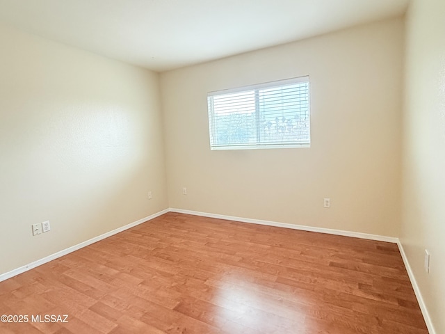 spare room with light hardwood / wood-style flooring