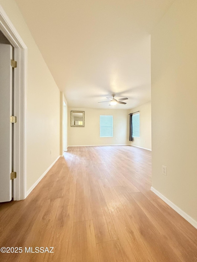 unfurnished room featuring ceiling fan and light hardwood / wood-style flooring