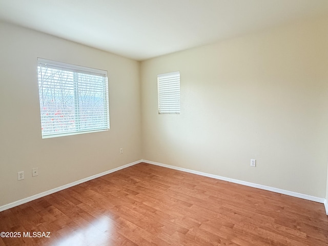 empty room featuring a healthy amount of sunlight and light wood-type flooring