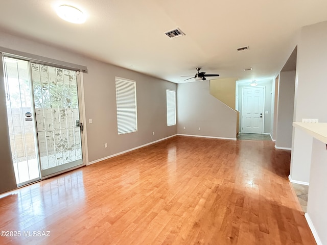 empty room featuring ceiling fan and light hardwood / wood-style flooring