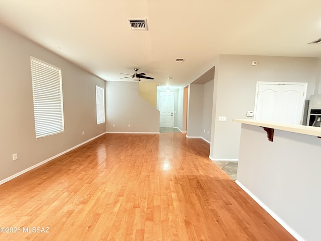 empty room featuring ceiling fan and light hardwood / wood-style floors