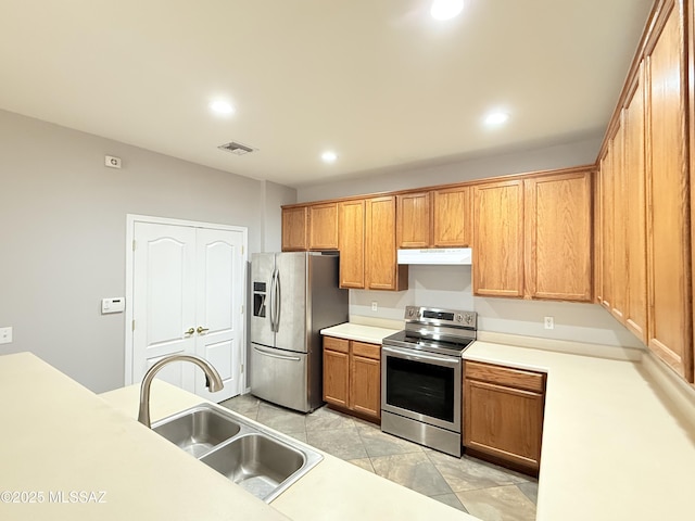 kitchen with sink, light tile patterned floors, and appliances with stainless steel finishes