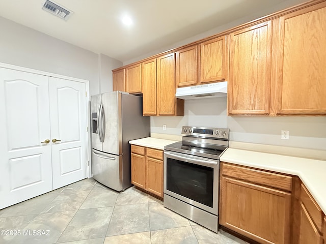 kitchen featuring appliances with stainless steel finishes and light tile patterned floors