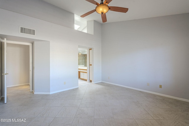 unfurnished bedroom featuring baseboards, visible vents, ensuite bath, ceiling fan, and high vaulted ceiling