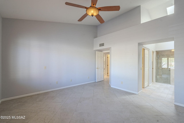 empty room featuring high vaulted ceiling, a ceiling fan, visible vents, and baseboards