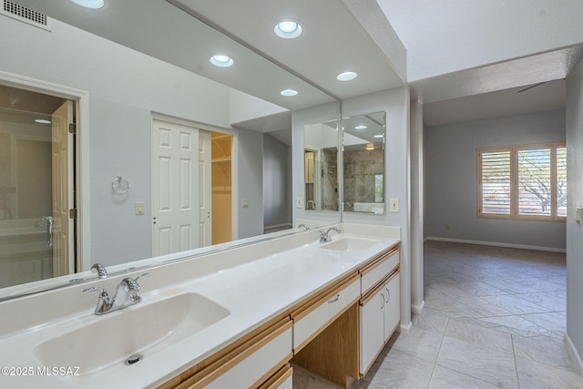 full bathroom featuring visible vents, a sink, baseboards, and double vanity