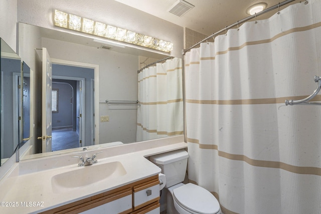 full bath with visible vents, vanity, and toilet