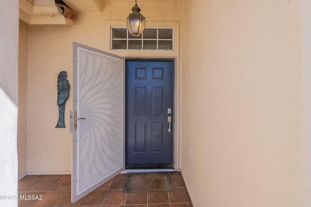 doorway to property featuring stucco siding