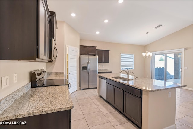 kitchen featuring appliances with stainless steel finishes, light stone counters, sink, a chandelier, and an island with sink