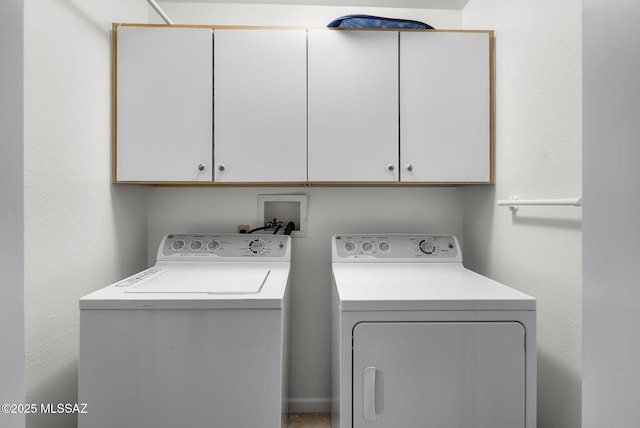 laundry room with cabinets and independent washer and dryer