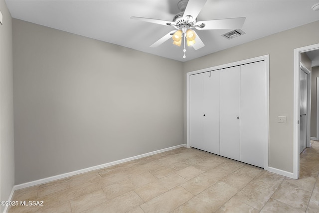 unfurnished bedroom with ceiling fan and a closet