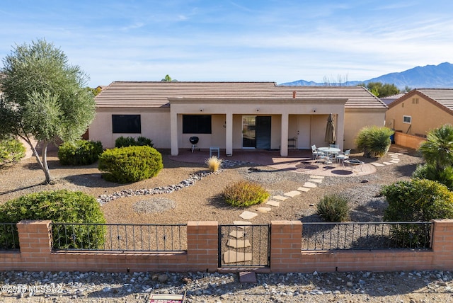 view of front of property featuring a mountain view and a patio area