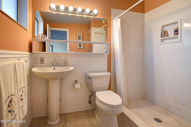 bathroom with sink, a shower with shower curtain, tile patterned flooring, and toilet