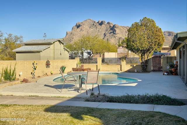 view of pool featuring a patio and a mountain view