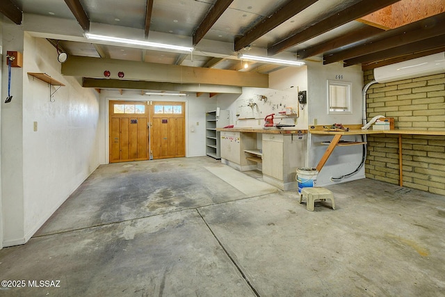 basement featuring brick wall, a wall mounted AC, and a workshop area