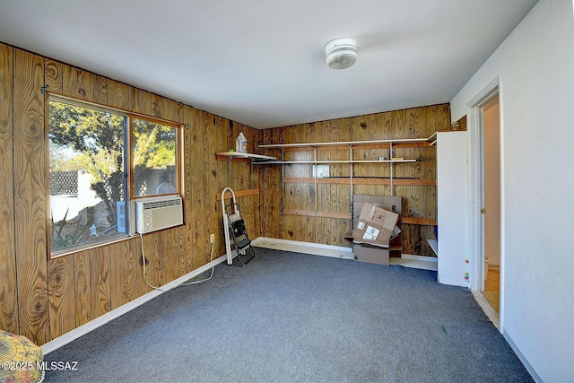 interior space with wood walls, cooling unit, and dark carpet