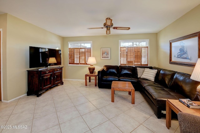 tiled living room featuring ceiling fan and plenty of natural light