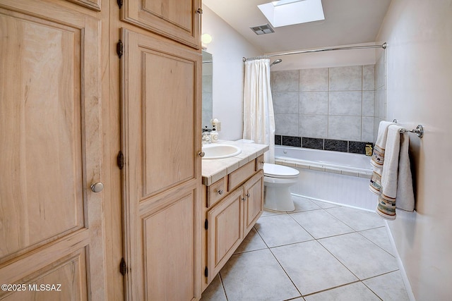 full bathroom with toilet, shower / bath combo, tile patterned floors, a skylight, and vanity