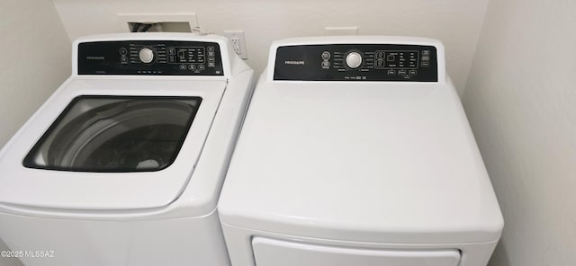 laundry room with washing machine and clothes dryer