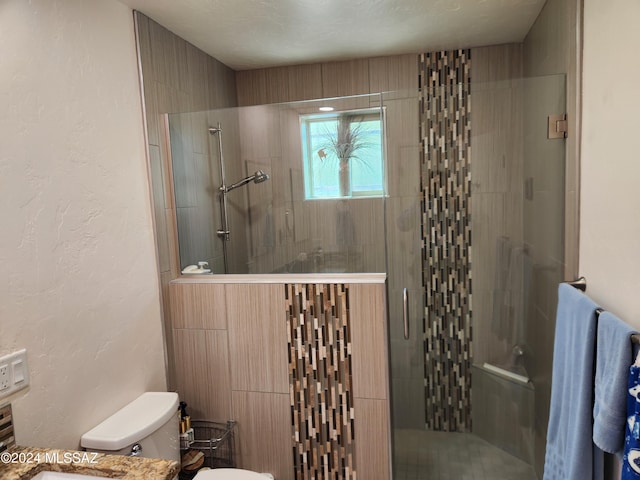 bathroom featuring toilet and walk in shower