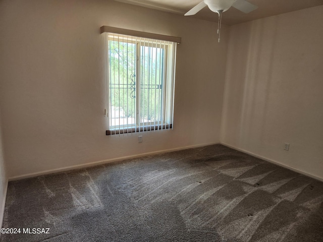 spare room featuring carpet flooring and ceiling fan