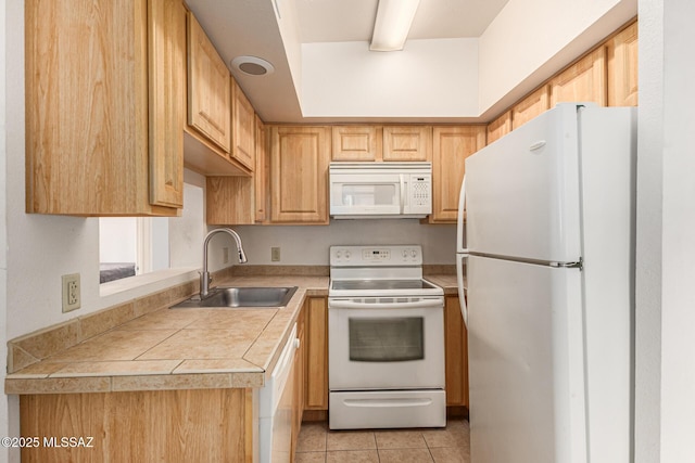 kitchen with sink, light tile patterned floors, and white appliances