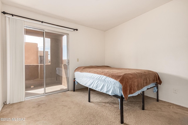 bedroom with carpet flooring, lofted ceiling, and access to outside