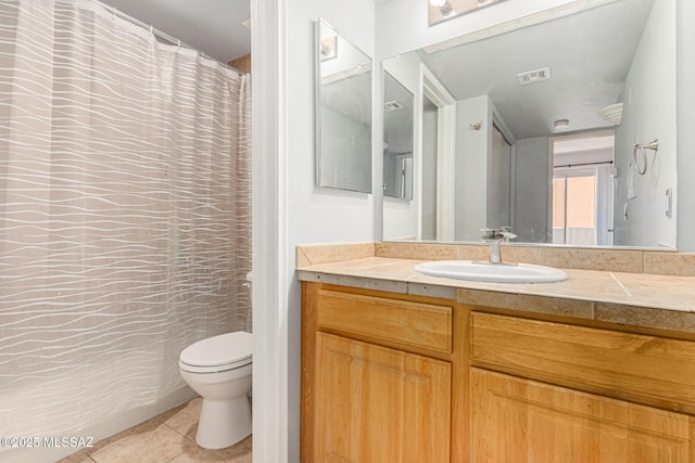 bathroom featuring tile patterned floors, vanity, and toilet