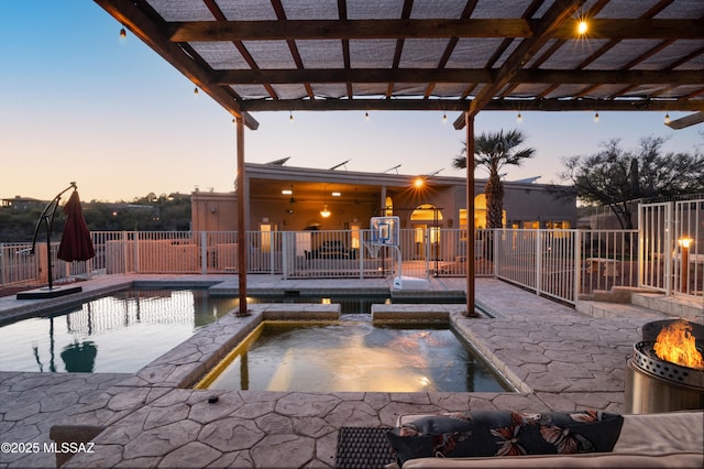 view of swimming pool with a pool with connected hot tub, fence, and a patio