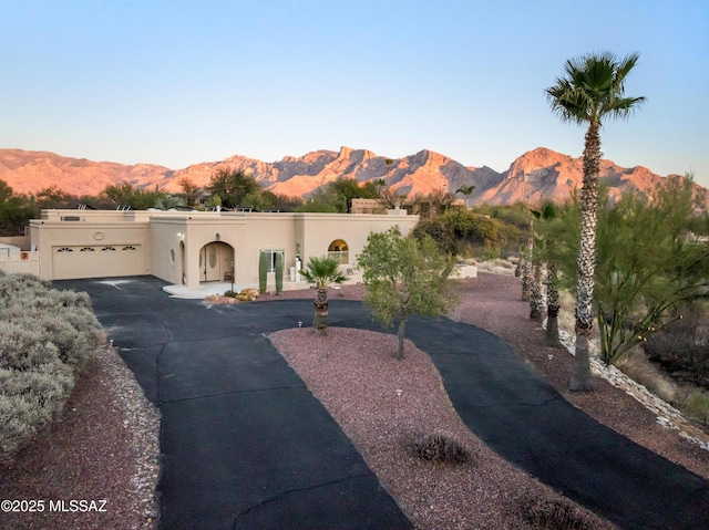 pueblo-style home with a mountain view and stucco siding