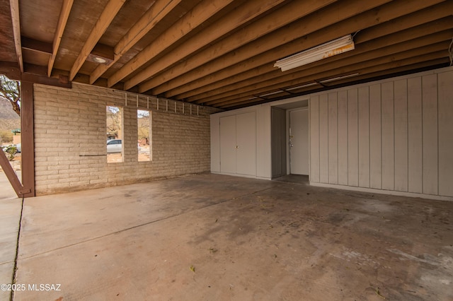 basement featuring brick wall