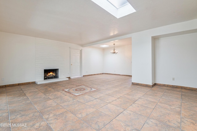 unfurnished living room featuring tile patterned flooring, a brick fireplace, and a notable chandelier