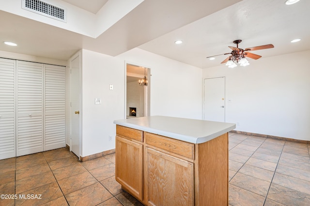 kitchen with a kitchen island and ceiling fan