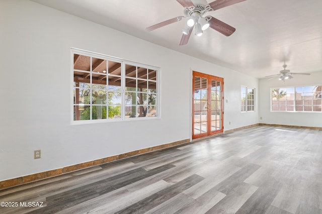 spare room featuring french doors, ceiling fan, and wood-type flooring