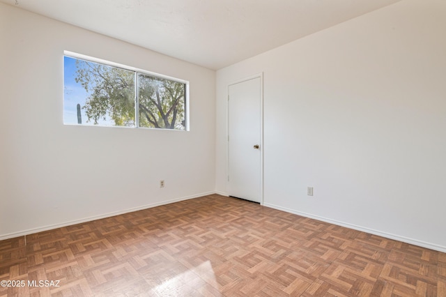 empty room with parquet flooring