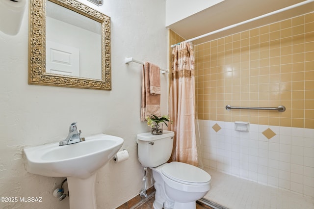 bathroom with sink, a shower with curtain, and toilet