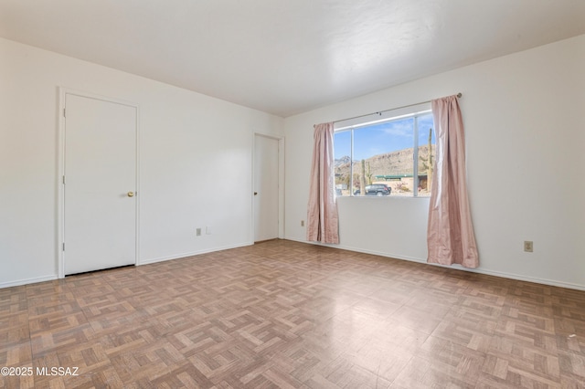 unfurnished room with light parquet flooring