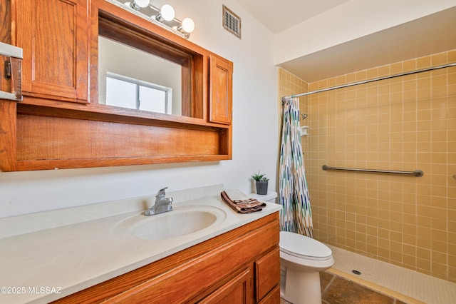 bathroom with vanity, curtained shower, and toilet