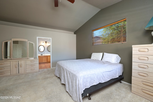 carpeted bedroom featuring ensuite bath, ceiling fan, sink, and vaulted ceiling