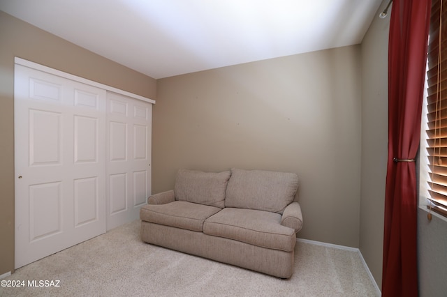 sitting room featuring light carpet