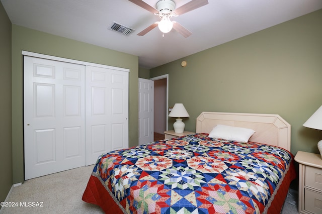 bedroom featuring a closet, ceiling fan, and light colored carpet