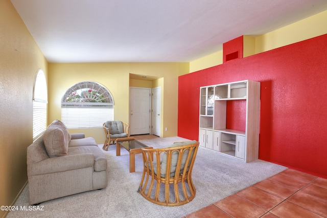 carpeted living room featuring lofted ceiling