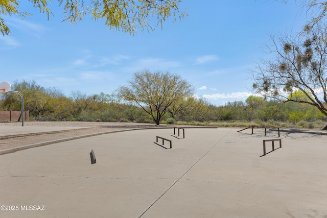 view of home's community featuring basketball hoop