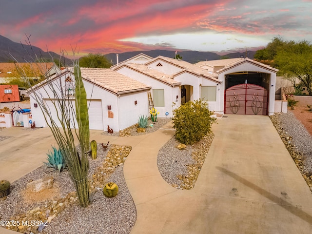 view of front of property featuring a garage and a mountain view