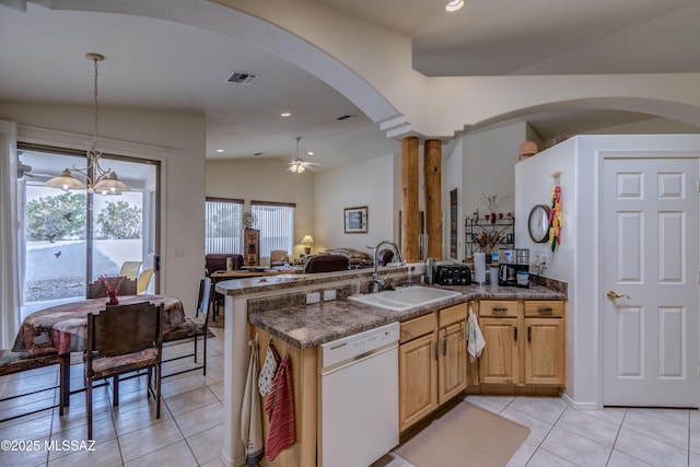 kitchen with dishwasher, vaulted ceiling, light tile patterned floors, pendant lighting, and sink