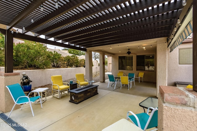 view of patio featuring ceiling fan, a fire pit, and a pergola