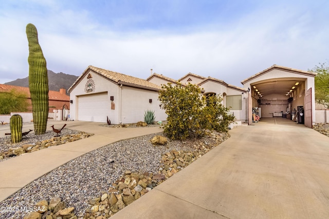 view of front of home with a garage and a mountain view