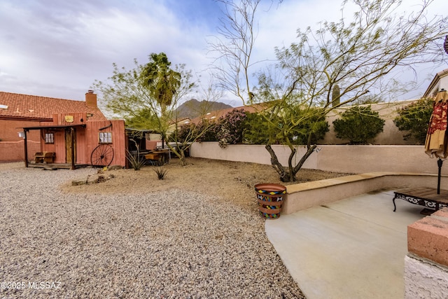 view of yard with a patio and a mountain view